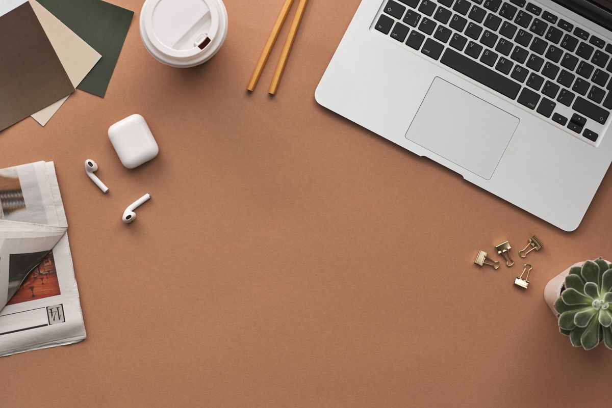 A laptop and a cup of coffee on a home desk, the kind of low-key setup a solo founder works from each morning